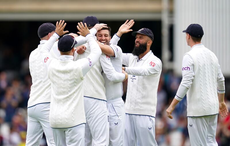 England's Mark Wood, centre, celebrates the wicket of Australia's Marnus Labuschagne with teammates. PA