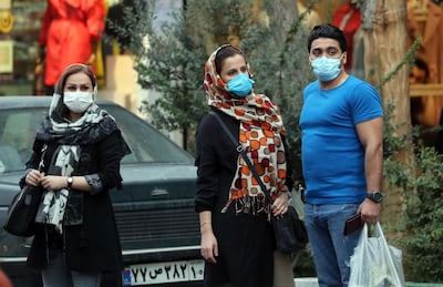 epa08724489 Iranians wearing face masks wait for a taxi in a street of Tehran, Iran, 06 October 2020. According to the Iranian Health ministry, Iran reported its highest daily COVID-19 infections by announcing 4151 new infections in past 24 hours and 227 death toll as it appears that Iran is in the grip of a third wave of COVID-19 outbreak.  EPA/ABEDIN TAHERKENAREH