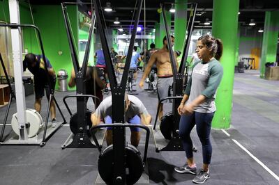 DUBAI , UNITED ARAB EMIRATES , MAY 21 – 2018 :- Nuha Al Marri , an Emirati athlete  ( right ) giving training during the Ramadan at Crossfit Metalize in Ras Al Khor area in Dubai.  ( Pawan Singh / The National )  For Sports. Story by Ramola