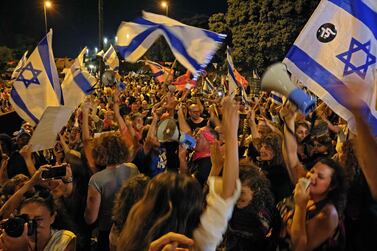 Israelis celebrate the confirmation of a new coalition government, in front of the Knesset in Jerusalem. AFP