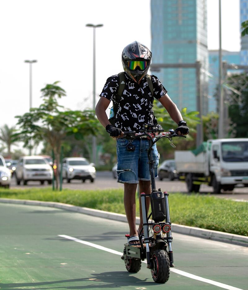 E-scooter riders are a common sight along the Corniche bicycle pathway in Abu Dhabi on May 5th, 2021. Victor Besa / The National.