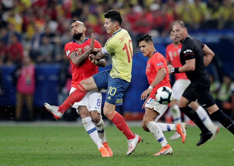 Colombia's James Rodriguez in action with Chile's Arturo Vidal. Reuters