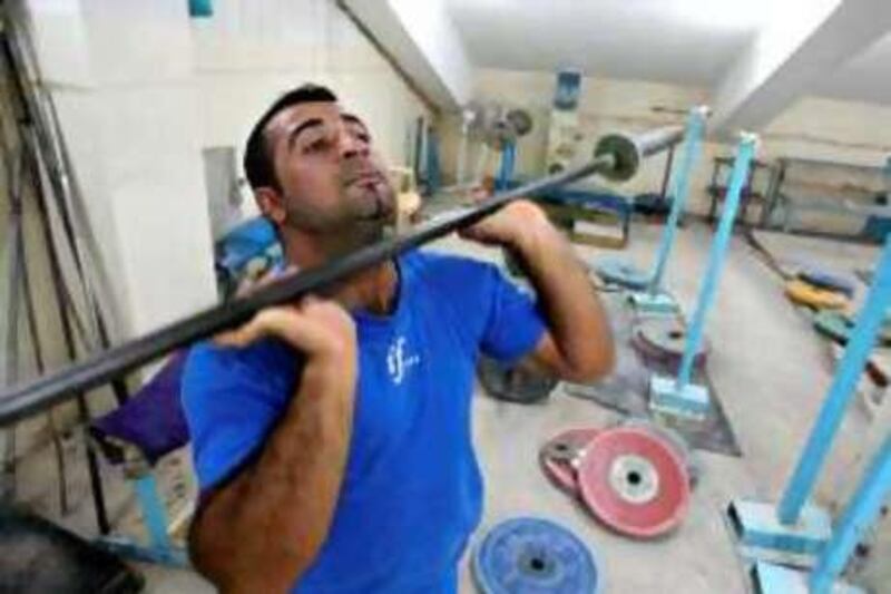 ARBIL, IRAQ, June 16, 2008: Iraqi weightlifter Sawara Mohammad, Iraq's only weightlifting competitor in this year's Beijing Olympics, trains at a gym in Arbil, 350 kilometres north of Baghdad. AFP PHOTO/ALI AL-SAADI

REF na27JL-iraq-olympics 27/07/08