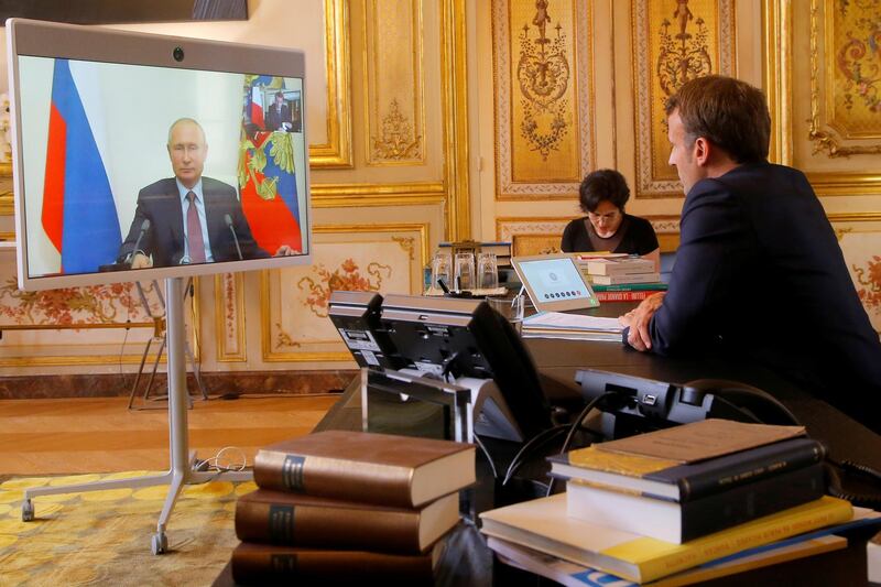 French President Emmanuel Macron talks with Russian President Vladimir Putin during a video conference at the Elysee Palace in Paris, France, June 26, 2020. Michel Euler/Pool via REUTERS