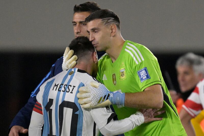 Argentina goalkeeper Emiliano Martinez kisses Lionel Messi's head at the final whistle in a 1-0 win over Paraguay. AFP