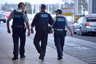 Police walk outside the international terminal as they patrol Sydney Airport. AFP