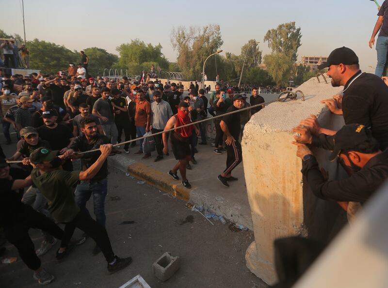 Supporters of a political alliance of Iran-backed groups attempt to storm government areas in the heavily fortified Green Zone in Baghdad, Iraq. AP