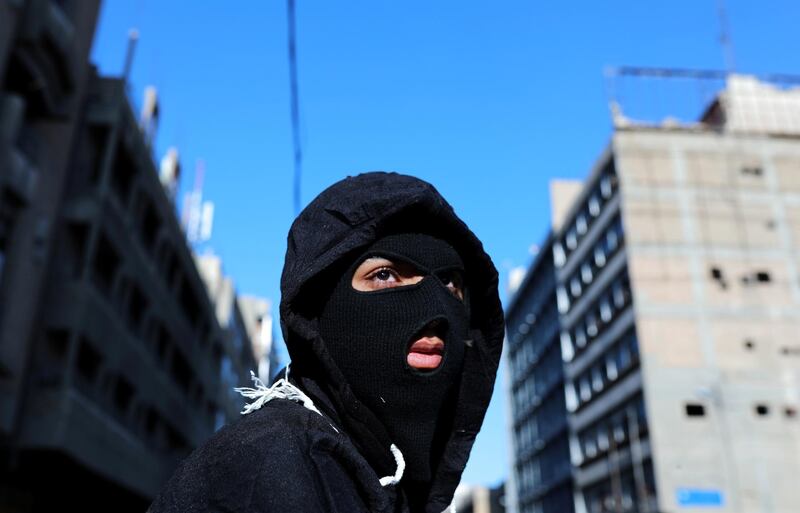 A masked demonstrator is seen during ongoing anti-government protests. Reuters