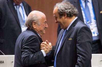 Sepp Blatter (L) shakes hands with former Uefa president Michel Platini after his election as Fifa president in 2015. EPA