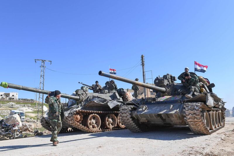 Syrian army units advance in the town of al-Eis in south Aleppo province on February 9, 2020, following battles with rebels and jihadists. Al-Eis, which overlooks the M5, was on a front that saw fierce fighting between the regime and its opponents in 2016. Syrian troops advancing north of Idlib linked up near Al-Eis with their comrades pushing south of Aleppo on Saturday, state news agency SANA said. The two units had recently waged separate battles in rural Aleppo and southern Idlib, but are now conjoined for the first time as they push north along the M5 highway.
 / AFP / -
