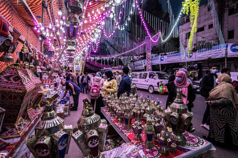 People shop from a stall selling Ramadan lanterns along a main street in the in a northern suburb of Egypt's capital. AFP