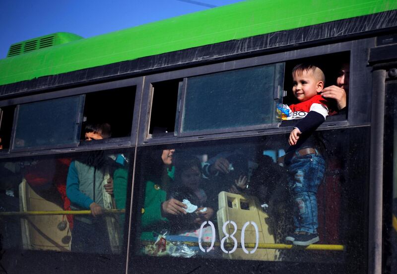 A refugee child looks out of a bus window that will take them home to Syria, in the northern Beirut suburb of Burj Hammoud, Lebanon. AP Photo