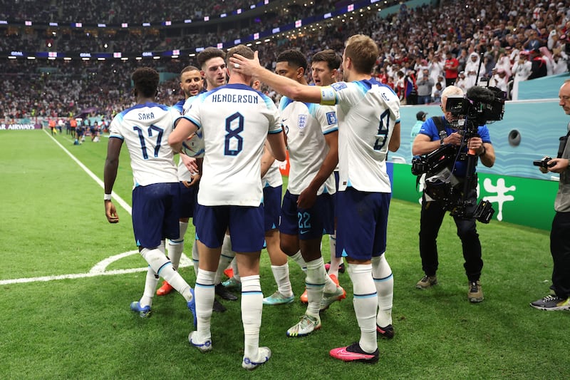 Harry Kane celebrates with his teammates after levelling at 1-1 from the penalty spot. Getty