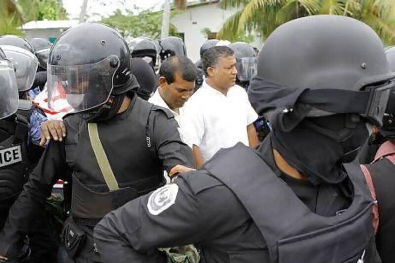 Police arrested last year the former Maldives president Mohamed Nasheed, centre left, the country's first democratically-elected president, after he failed to turn up for the start of a trial for abuse of power. Ho / AFP