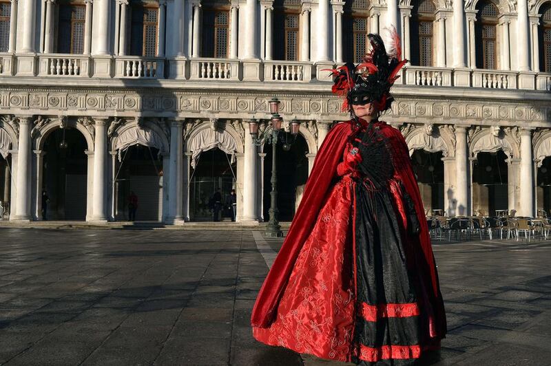 A carnival reveller poses on St Mark’s square in Venice, Italy, on February 23, 2014. This year's edition is titled  “Wonder and Fantasy Nature” and runs from February 15 to March 4, 2014. Gabriel Bouys / AFP photo