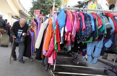 A shopper at a popular outdoor clothes market in Cairo's Bulaq district. EPA