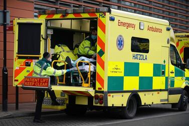 Paramedics transfer a patient from an ambulance into the Royal London Hospital London last week as Britain experiences the highest Covid death rate in the world. AP