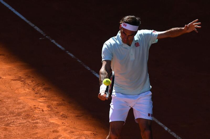 Federer returns a serve from Thiem. AFP