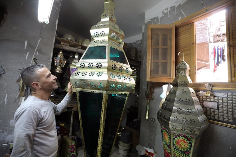 Egyptian craftsman Shreif Rashwan makes traditional Ramadan lanterns, called Fanous, at a workshop in Cairo, Egypt, on April 8, 2020. EPA