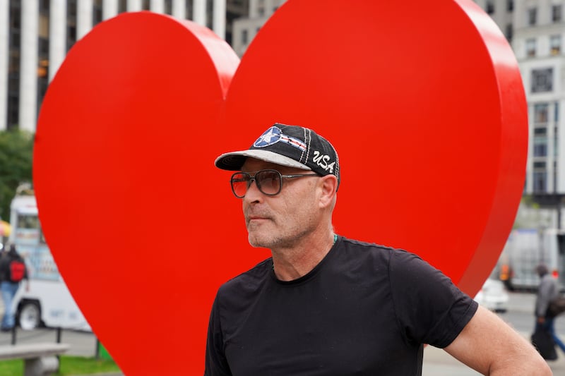 Italian sculptor Sergio Furnari poses for pictures in front of 'The Hero Monument' heart sculpture on October 25, 2021, in New York. AP