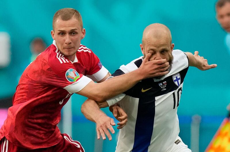 Finland's Teemu Pukki takes one in the eye from Dmitri Barinov of Russia in the Euro 2020 match at the Saint Petersburg stadium on Wednesday, June 16. Russia won the game 1-0. AP
