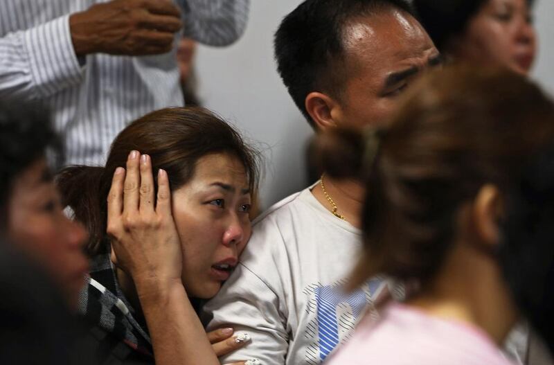 Family of passengers onboard AirAsia flight QZ8501 react at a waiting area in Juanda International Airport, Surabaya December 28, 2014. Indonesia's air force was searching for the AirAsia plane carrying 162 people that went missing on Sunday after the pilots asked to change course to avoid bad weather during a flight from the Indonesian city of Surabaya to Singapore. The Airbus 320-200 lost contact with Jakarta air traffic control at 6:17 a.m. (2317 GMT), officials said.   REUTERS/Beawiharta (INDONESIA - Tags: DISASTER TRANSPORT ENVIRONMENT)