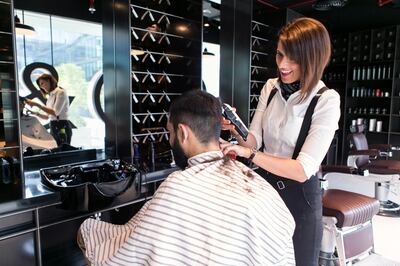 DUBAI, UNITED ARAB EMIRATES, 23 JULY 2017. 

Sammie, allegedly the first female barber in the UAE, cuts Adel's hair, at Chaps & Co in Dubai Design District.

(Photo by Reem Mohammed / The National)

Reporter: Hafsa Lodi
Section: AC
