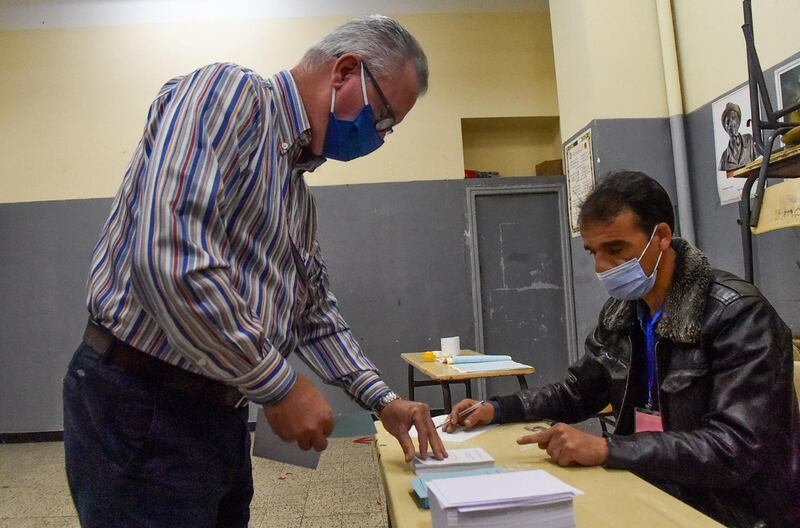 An Algerian man prepares to vote at a polling station in the capital Algiers. AFP