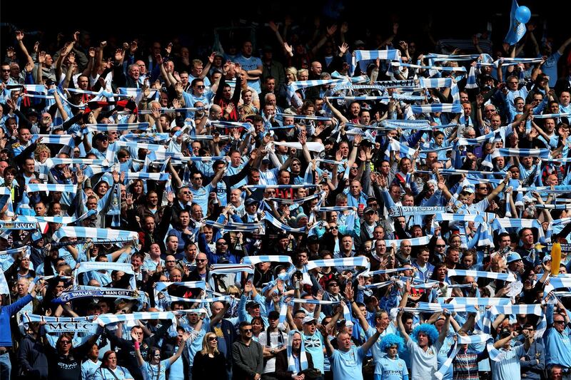 MANCHESTER, ENGLAND - MAY 13:  Manchester City fans cheer on their team during the Barclays Premier League match between Manchester City and Queens Park Rangers at the Etihad Stadium on May 13, 2012 in Manchester, England.  (Photo by Alex Livesey/Getty Images)