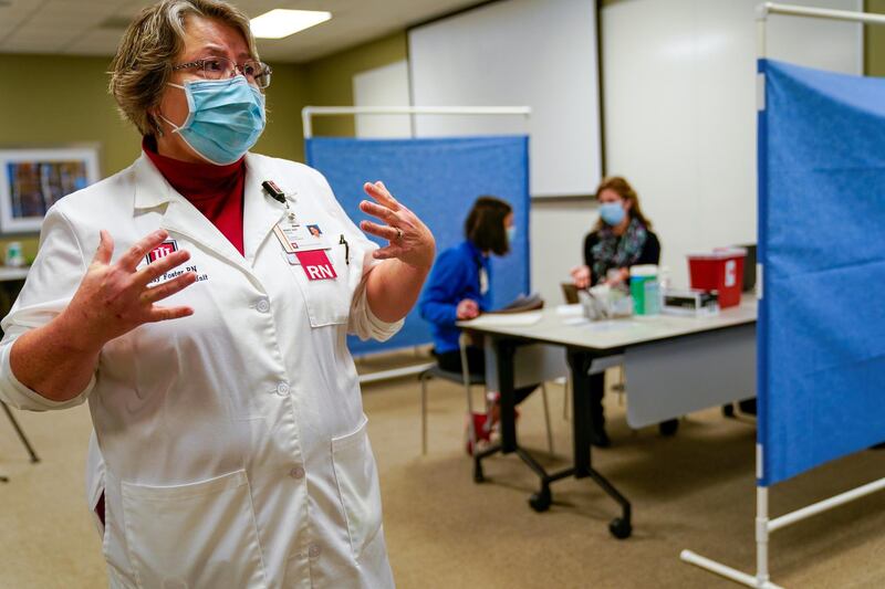 Program Director Mary Kay Foster describes the work of healthcare workers taking part in a rehearsal for the administration of the Pfizer vaccine at Indiana University Health in Indianapolis, Indiana, US. Reuters