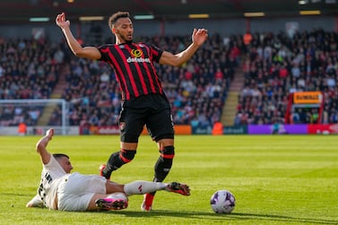Manchester United's Diogo Dalot, left, duels for the ball with Bournemouth's Lloyd Kelly during the English Premier League soccer match between Bournemouth and Manchester United, at The Vitality Stadium in Bournemouth, England, Saturday, April 13, 2024.  (AP Photo / Kirsty Wigglesworth)