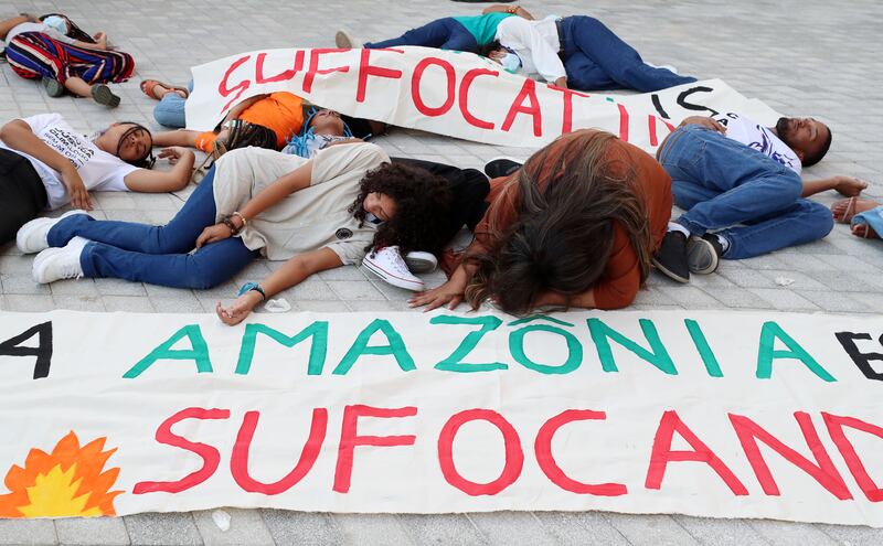 Young activists from Engajamundo protest about smog being created from deforestation in the Amazon. Chris Whiteoak / The National