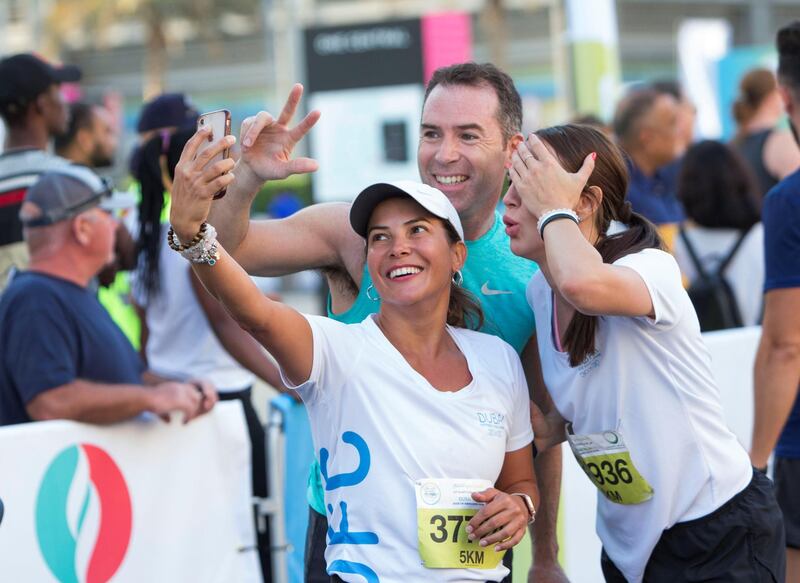 Dubai, United Arab Emirates - Participants at the finish line at the Dubai 30x30 Run at Sheikh Zayed Road.  Leslie Pableo for The National