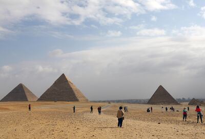 Tourists visit the area of the Great Pyramids in Giza, on the outskirts of Cairo, Egypt January 18, 2020. REUTERS/Marius Bosch