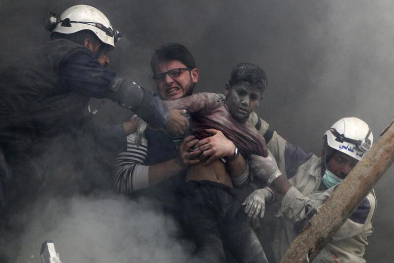 Syrian white helmet activists rescue a boy from under the rubble after what activists said were explosive barrel bombs were dropped by forces loyal to Syria's president Bashar Al Assad in Aleppo. Hosam Katan / Reuters 