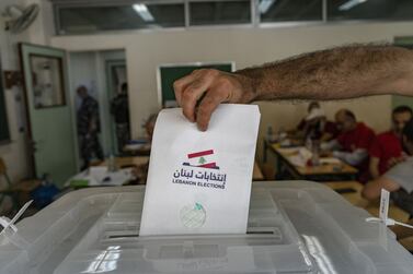 A voter casts their ballot at a polling station during parliamentary elections in Beirut, Lebanon, on Sunday, May 15, 2022.  Lebanon heads to the polls with its economy in the grip of hyperinflation, with the currency in freefall after the government defaulted on over $30 billion in international debt. Photographer: Francesca Volpi / Bloomberg