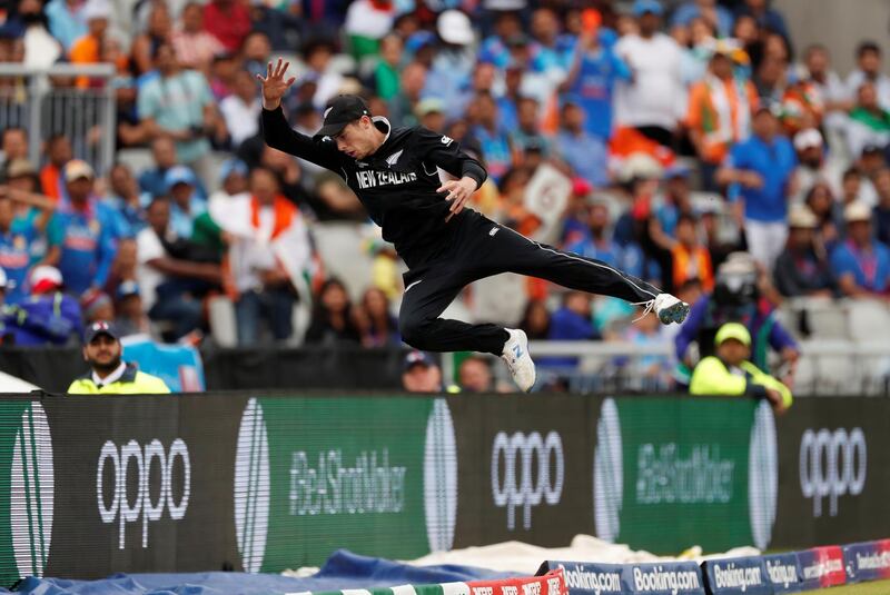 New Zealand's Mitchell Santner makes an acrobatic attempt to stop a MS Dhoni six. Reuters