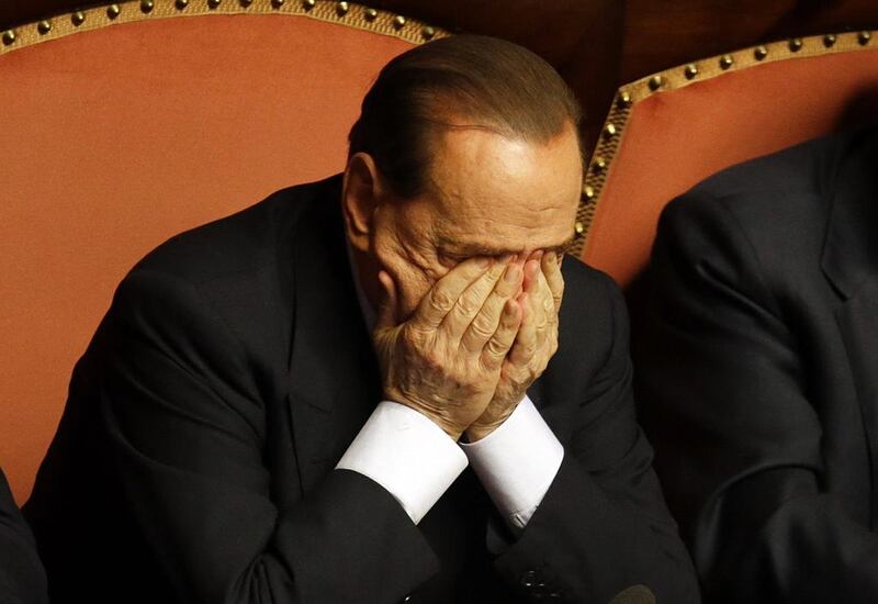 People of Freedom party leader Silvio Berlusconi rubs his eyes after delivering his speech at the Senate, in Rome. Gregorio Borgia / AP Photo