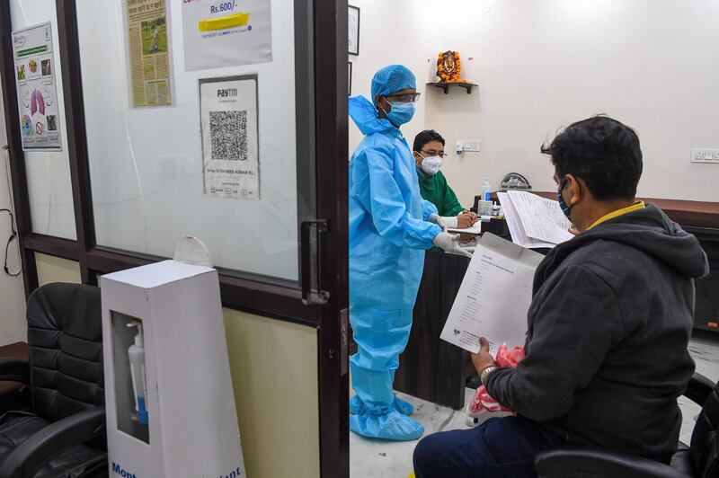 Lung specialist Davinder Kundra  checks the case history of a patient at his Breathe Better clinic in New Delhi. AFP