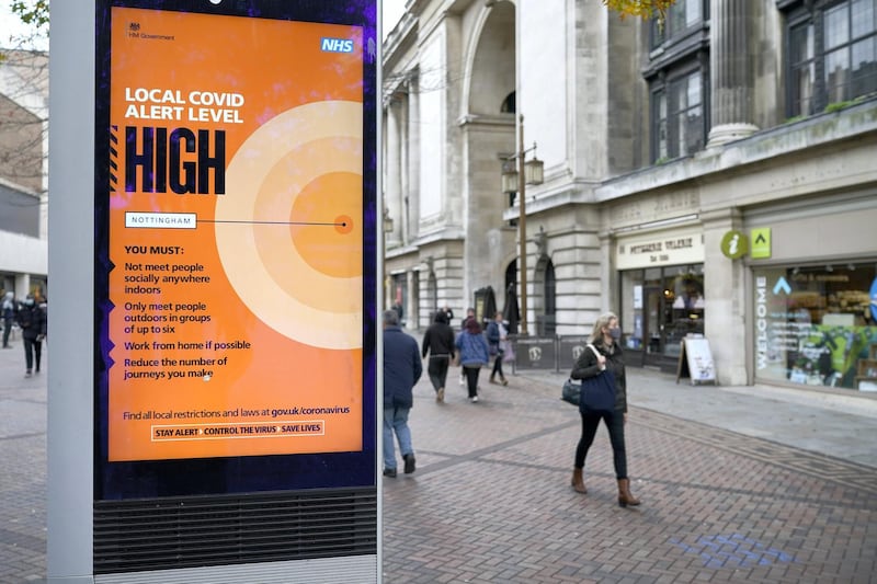 NOTTINGHAM, ENGLAND - OCTOBER 28: People walk through Nottingham City centre ahead of Tier Three restrictions on October 28, 2020 in Nottingham, England.  The city of Nottingham is set to join other parts of England in the Tier 3 'Very High' coronavirus (Covid-19) pandemic restrictions on Friday. (Photo by Christopher Furlong/Getty Images)