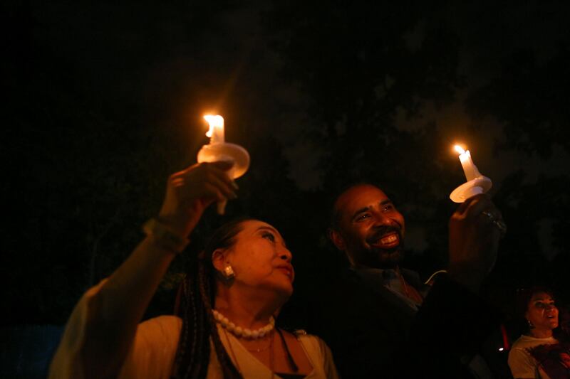 Music industry professionals Reiko Yukawa, Japan, and Boo Mitchell, Memphis, joined mourners who gathered to commemorate the 40th anniversary of the death of singer Elvis Presley at his former home of Graceland. Karen Pulfer Focht / Reuters