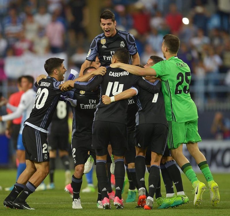 The Real Madrid squad celebrate winning the Primera Liga title following the La Liga match against Malaga. Aitor Alcalde / Getty Images