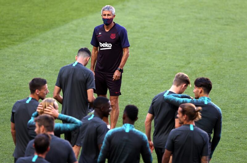 Quique Setien talks to the players during a training session ahead of Barcelona's Champions League quarter-final against Bayern Munich. Reuters