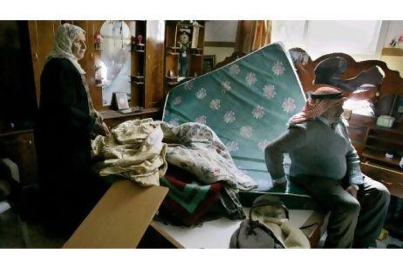 Palestinians survey the damage after their home was ransacked by Israeli soldiers in the West Bank hamlet of Awarta.