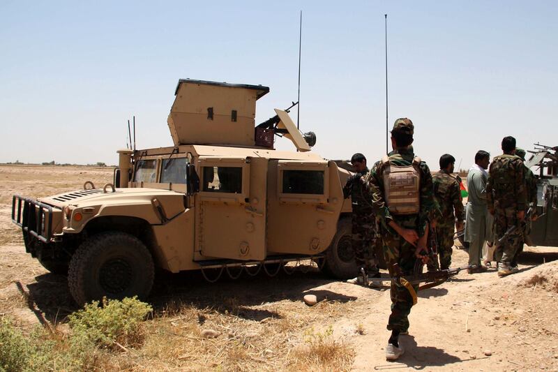 epa08485258 Afghan security officials patrol on highway in Helmand, Afghanistan, 14 June 2020. Although clashes between the Afghan security forces and the Taliban fighters continued in rural areas, attacks in cities had come down to almost nil.  EPA/WATAN YAR