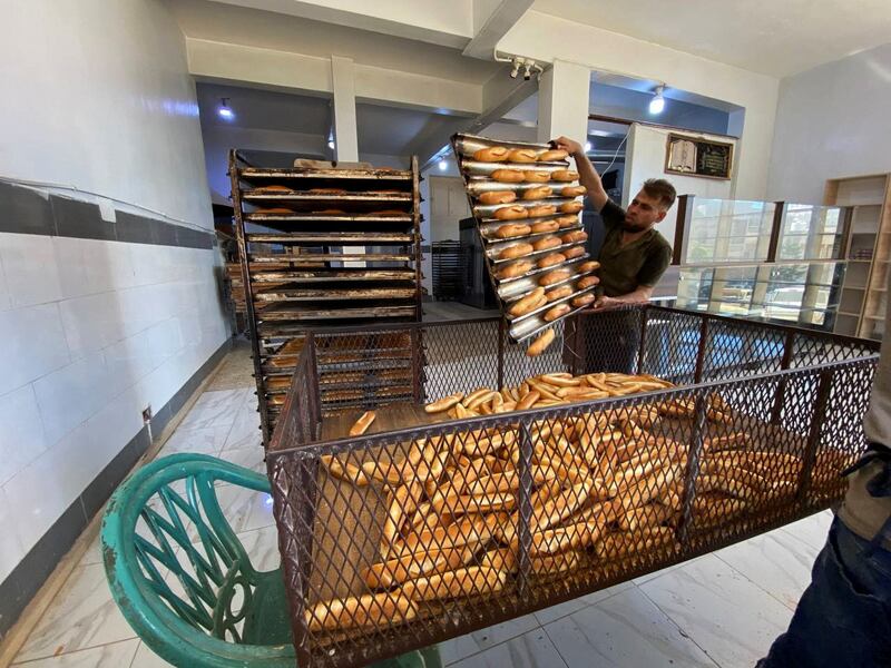 A worker puts bread in a box at a bakery, in the aftermath of the floods in Derna. Reuters