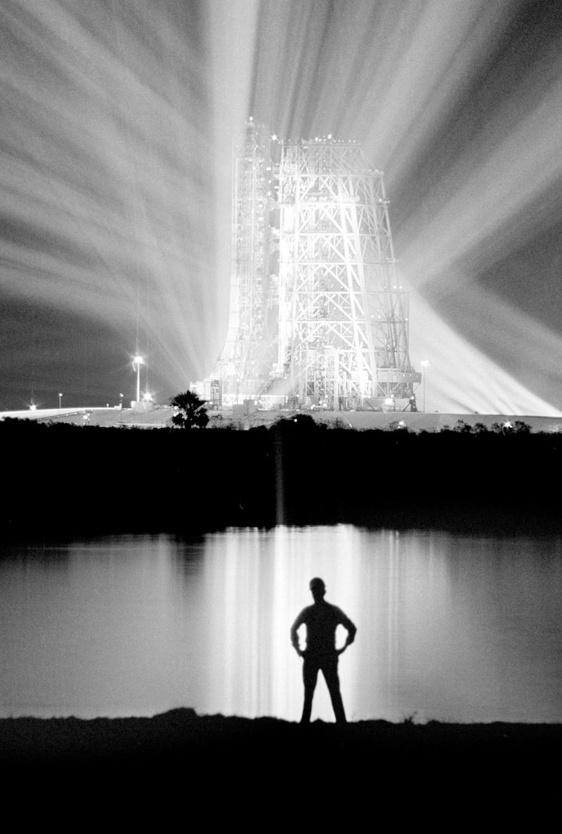 FILE - In this Dec. 19, 1968, file photo, spotlights illuminate the 363-foot-tall Saturn V booster rocket on the launch pad at the Kennedy Space Center in Florida, carrying the Apollo 8 spacecraft and its crew of three astronauts. (AP Photo/File)