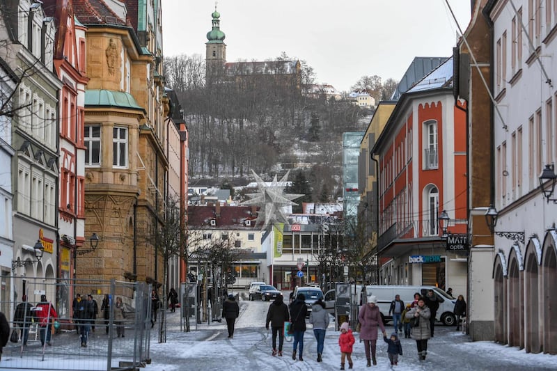 People walk through the city centre of Amberg, southern Germany, on January 2, 2019. A German far-right group has launched a vigilante street patrol in a Bavarian town where four Afghan and Iranian asylum seekers allegedly attacked passers-by last weekend. The mayor of Amberg, Michael Cerny, said he was "shocked" after the extremist NPD party posted photos online of four people wearing red protective vests to create "safe spaces", including outside a refugee centre.
 - Germany OUT
 / AFP / dpa / Armin Weigel
