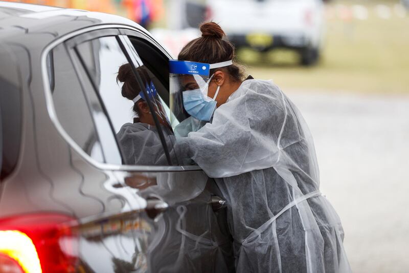 A medical worker talks to a person in a car as people line up at a coronavirus vaccination site at Strawberry Festival Fairgrounds in Plant City, Florida, US. Reuters