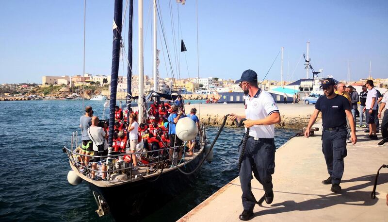 epa07699420 The Italian NGO Mediterranea Saving Humans' Alex migrant rescue ship carrying 41 migrants rescued off Libya Thursday docks at the port of Lampedusa, Sicily island, Italy, 06 July 2019. The boat carrying 41 migrants has docked in the Italian port despite a ban by Matteo Salvini, Italy's interior minister, who had vowed to block them.  EPA/ELIO DESIDERIO